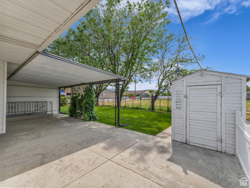 View of patio featuring a storage unit