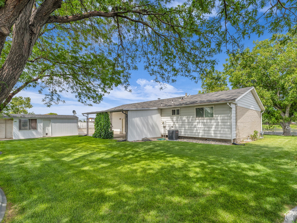 Back of property with an outdoor structure