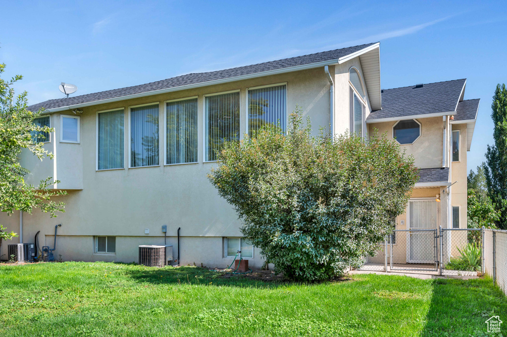 View of property exterior featuring stucco siding and a shingled roof