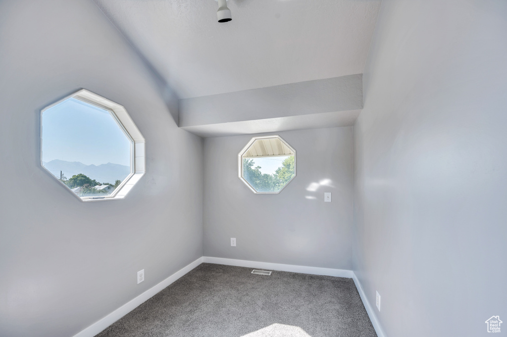 Carpeted empty room featuring baseboards