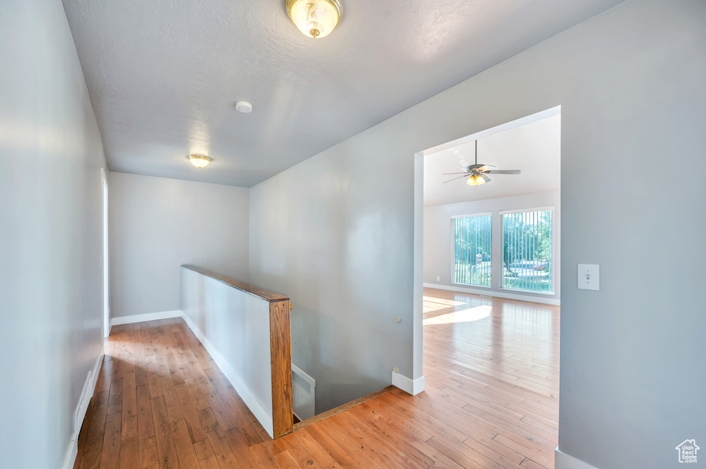 Hallway featuring an upstairs landing and hardwood / wood-style flooring