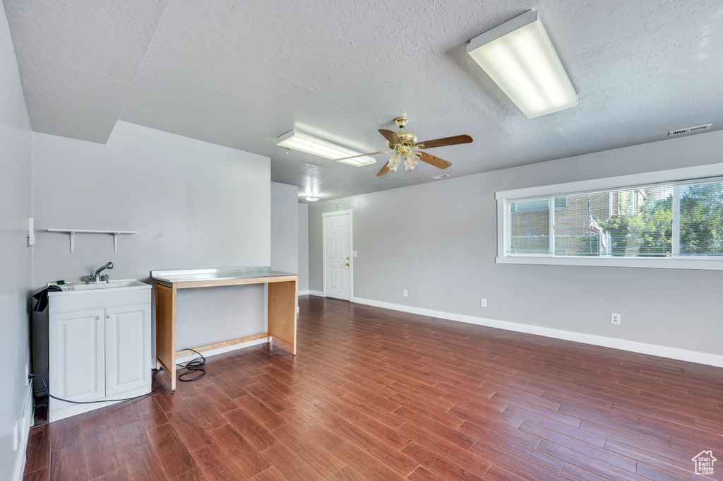 Spare room featuring a textured ceiling, wood finished floors, and ceiling fan