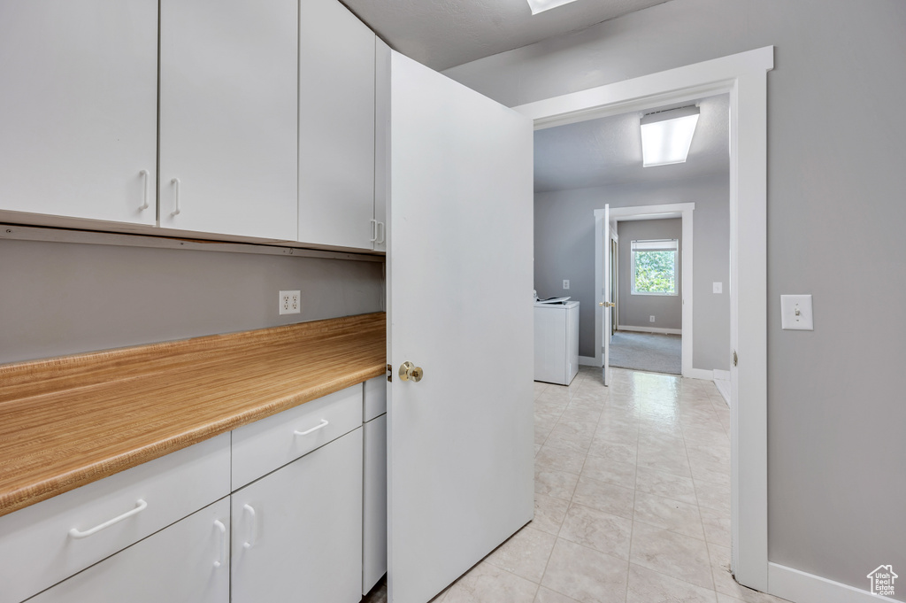 Kitchen featuring light countertops and white cabinetry