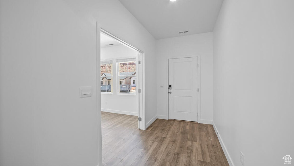 Hall featuring wood finished floors and baseboards