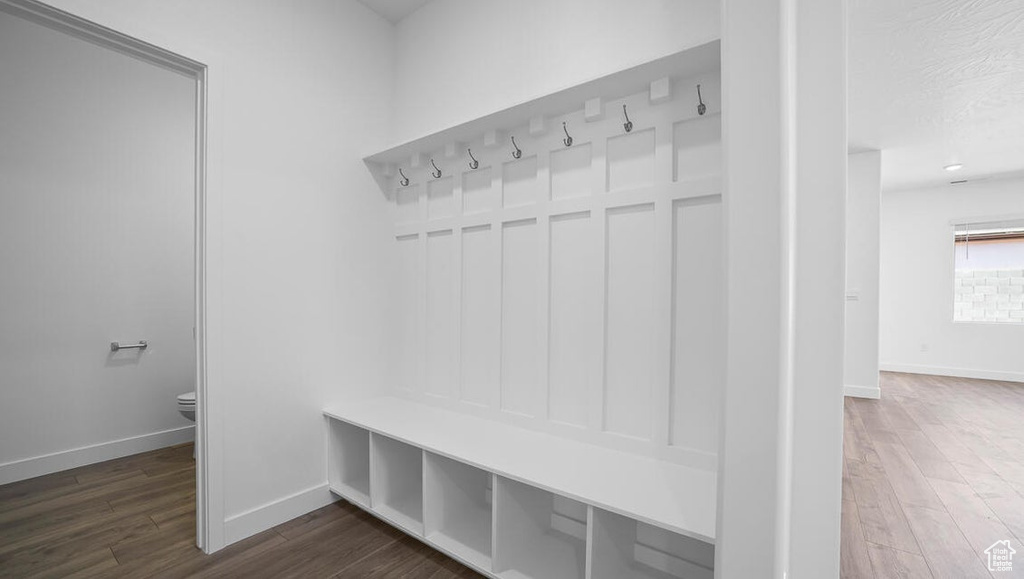 Mudroom with dark wood-style flooring and baseboards