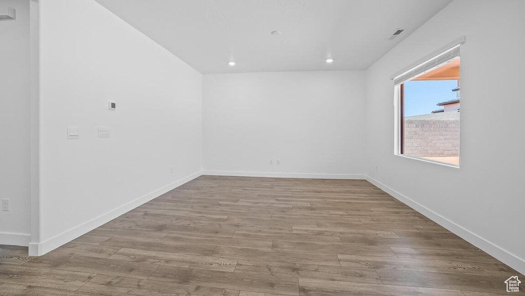 Empty room with wood finished floors and recessed lighting