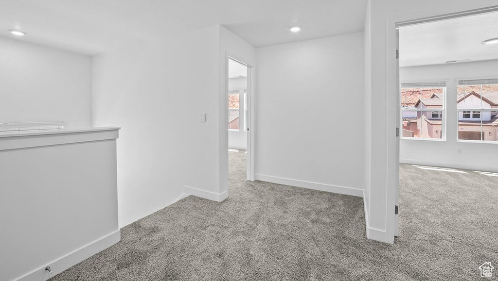 Corridor featuring carpet floors, an upstairs landing, and recessed lighting