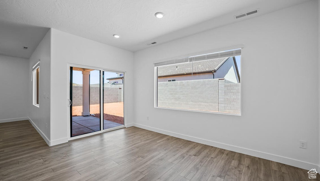 Spare room featuring wood finished floors and recessed lighting