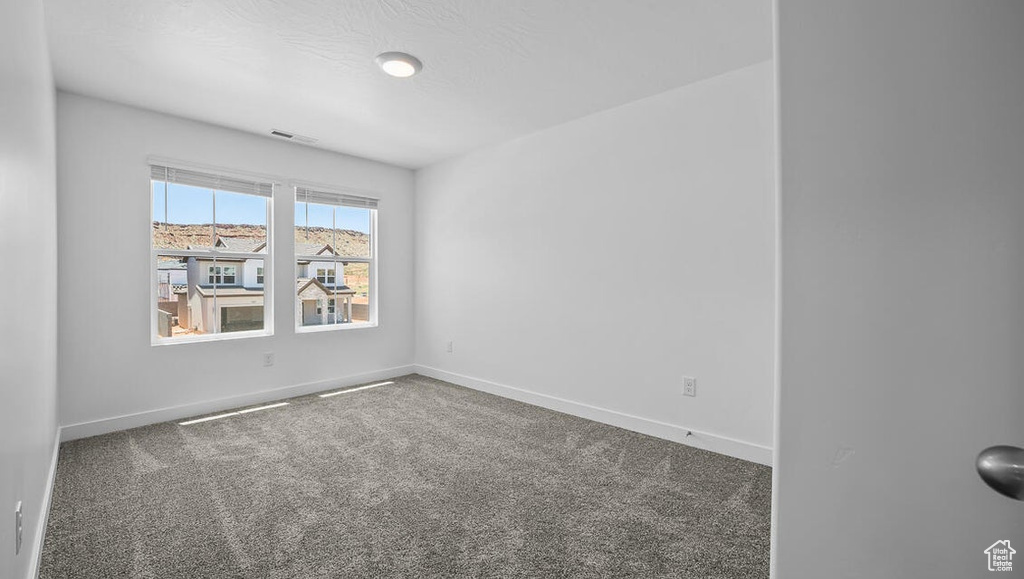 Spare room featuring carpet floors