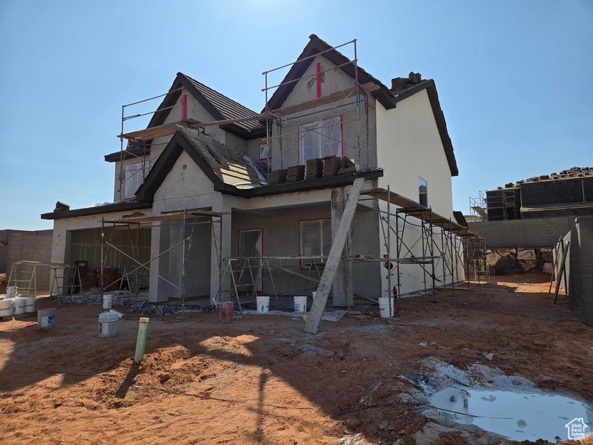 Rear view of property featuring stucco siding