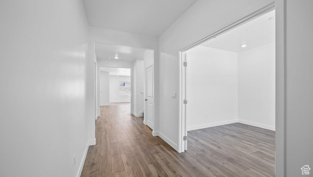 Hallway with wood finished floors and baseboards