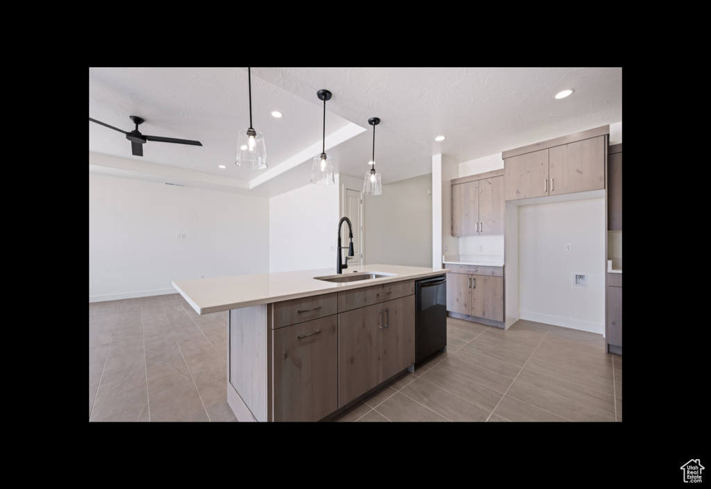 Kitchen featuring dishwasher, light tile patterned floors, light countertops, recessed lighting, and a kitchen island with sink