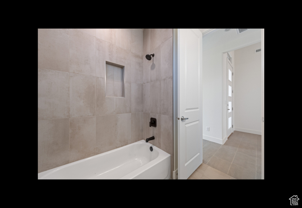 Full bathroom featuring shower / washtub combination and tile patterned flooring