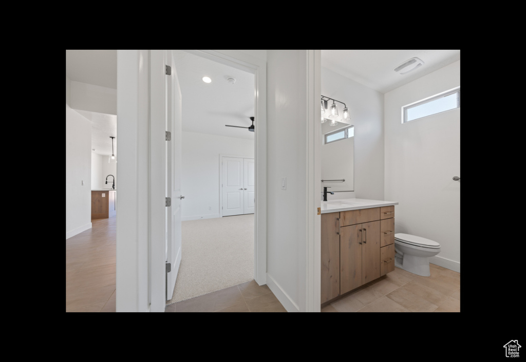 Bathroom with vanity, a ceiling fan, and tile patterned floors