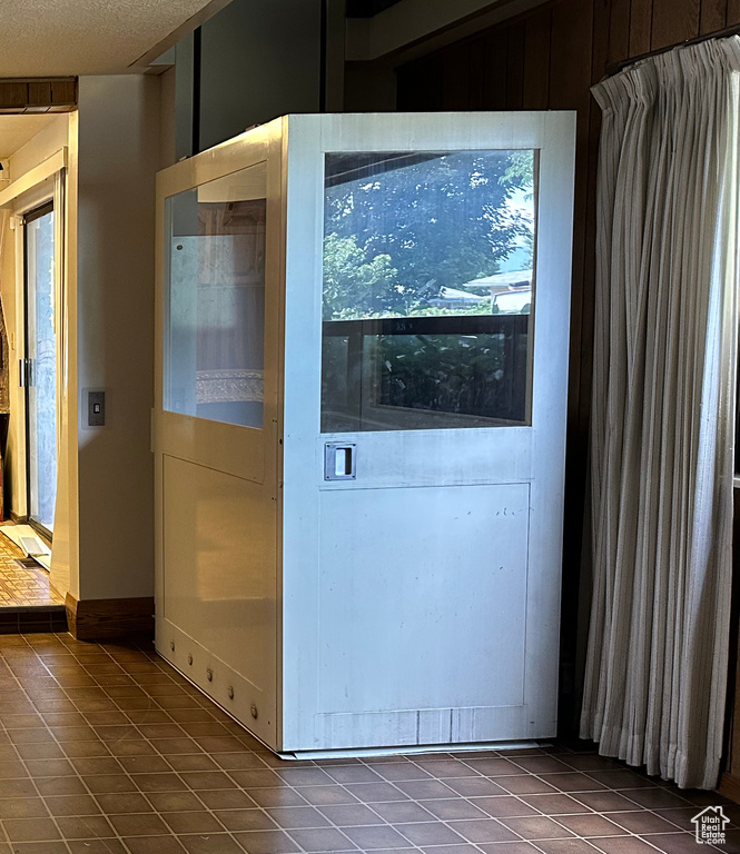 Doorway to outside with tile patterned floors