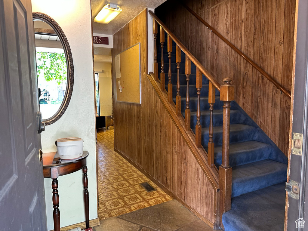 Stairs featuring tile patterned floors