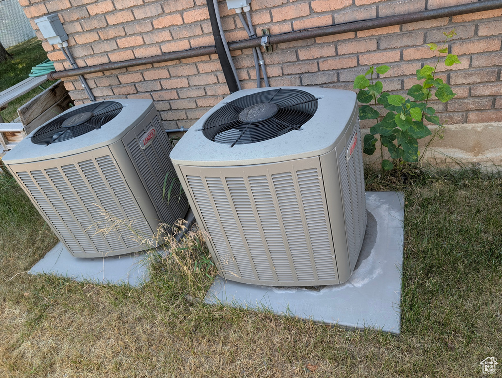 Exterior view of a cooling unit and brick siding