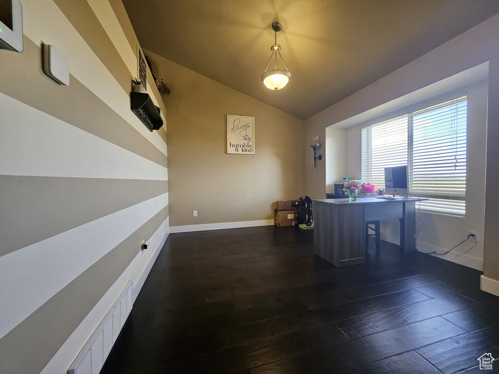 Office with lofted ceiling and dark wood-style flooring