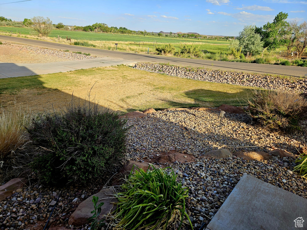 View of green lawn featuring a rural view