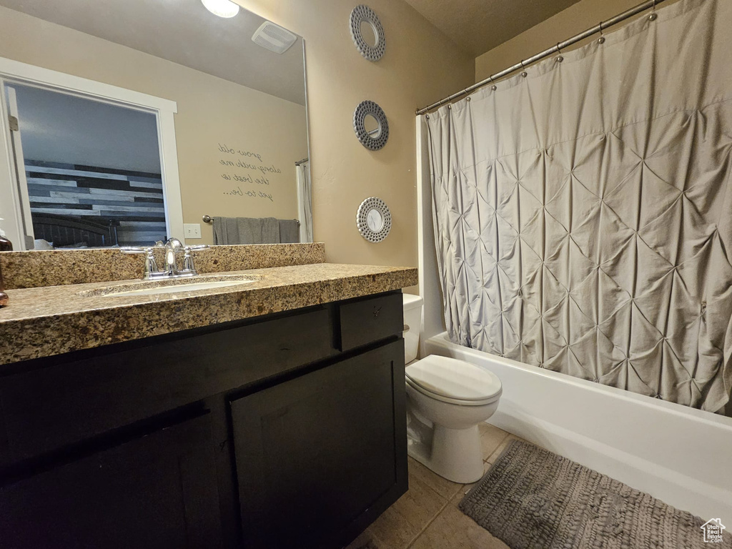 Full bath with vanity, tile patterned flooring, and shower / bath combination with curtain