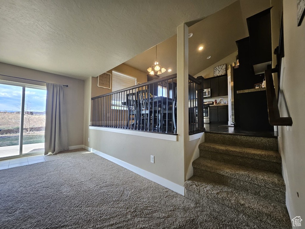 Stairway featuring a chandelier, carpet floors, and recessed lighting