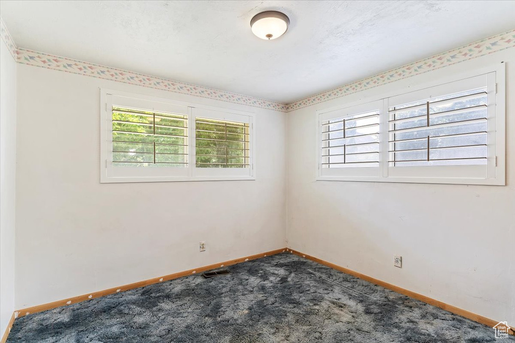 Carpeted empty room with plenty of natural light