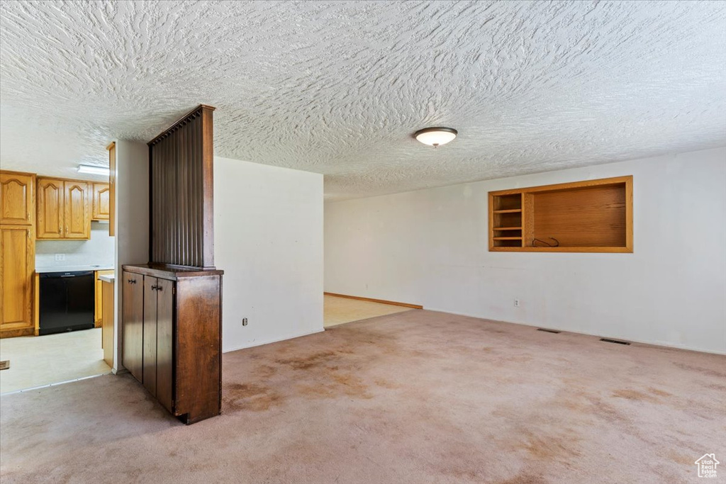 Empty room with light colored carpet