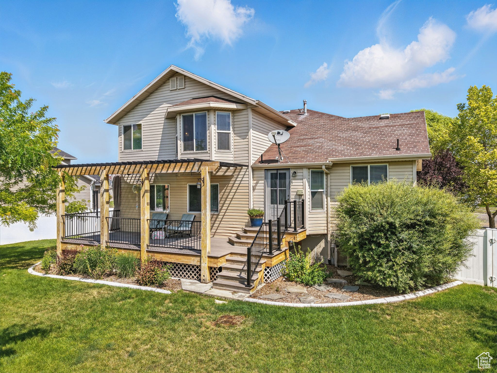 Rear view of property featuring roof with shingles