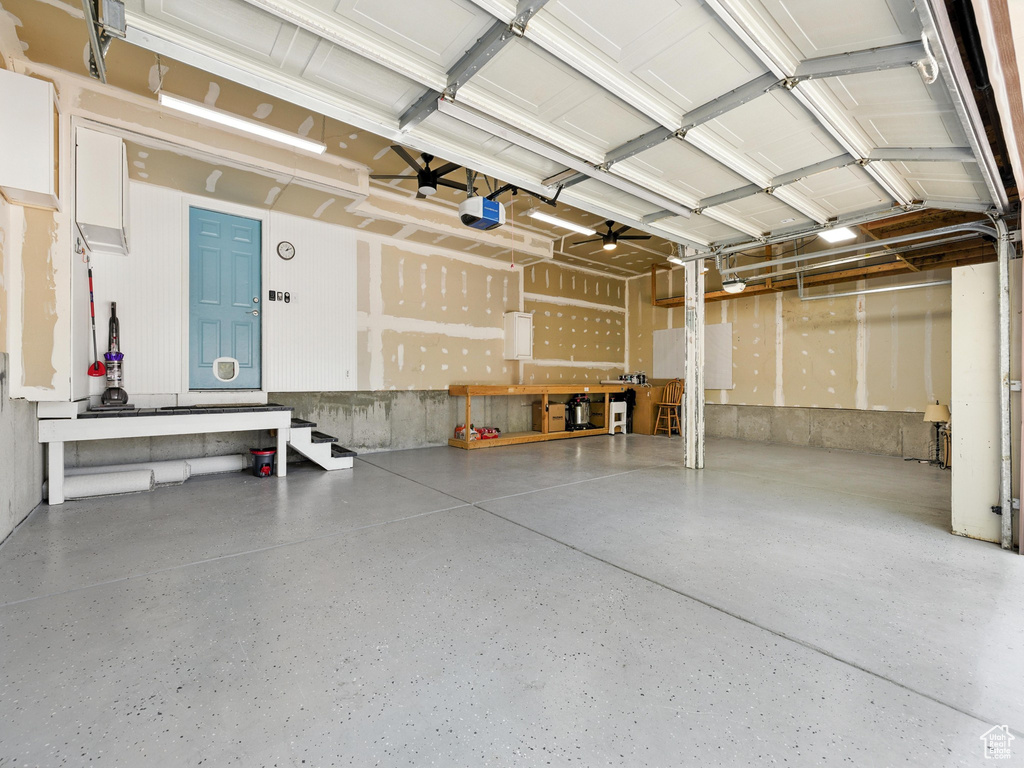 Garage with a garage door opener and a workshop area