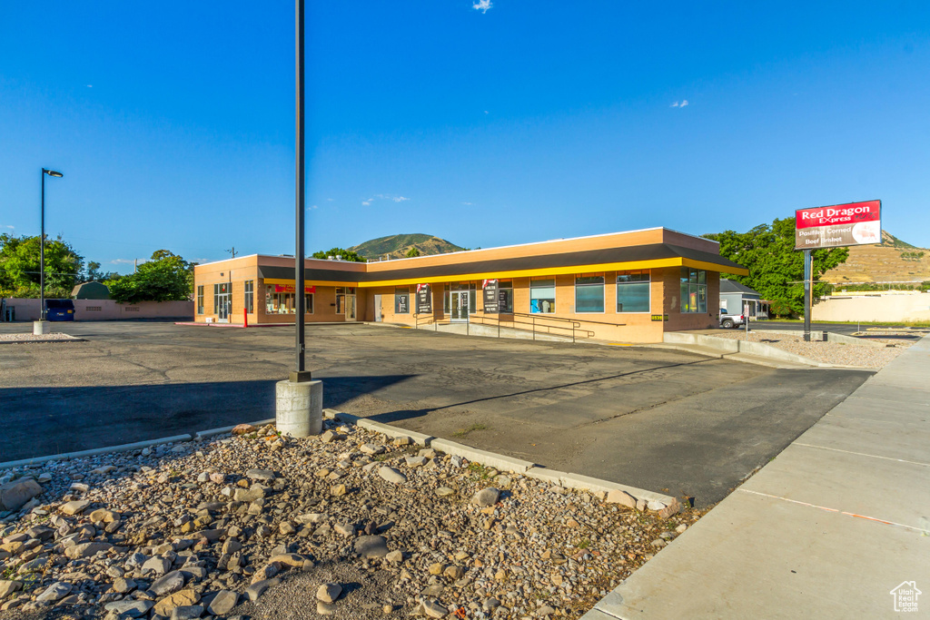 View of building exterior featuring uncovered parking