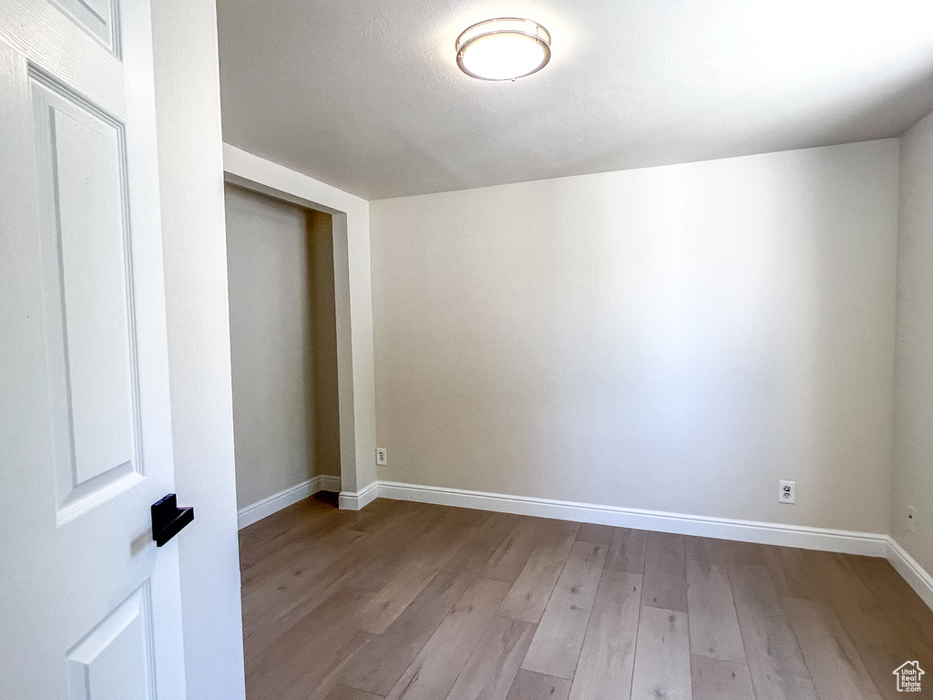 Empty room with baseboards and wood finished floors