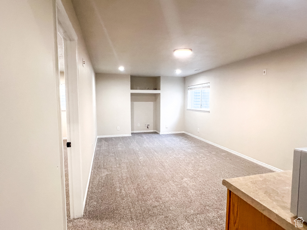 Basement with light colored carpet and recessed lighting