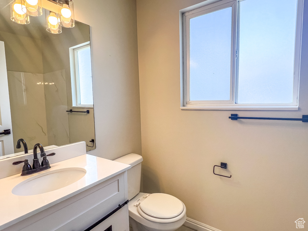 Full bath featuring vanity, a shower, and a chandelier
