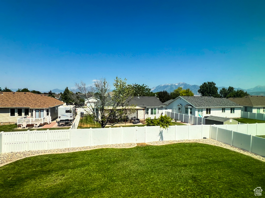 Fenced backyard with a residential view and a mountain view