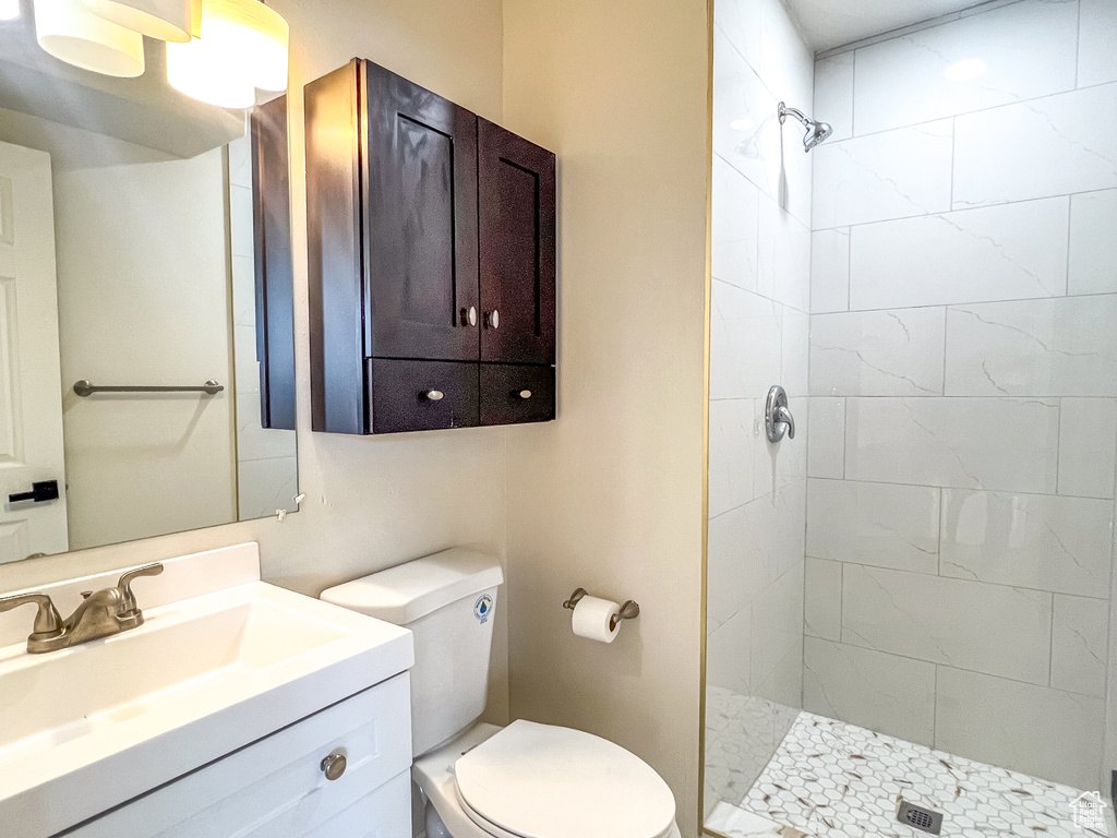Full bath with a tile shower and vanity