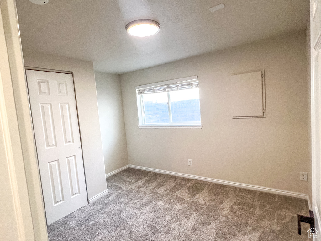 Unfurnished bedroom featuring carpet and a closet