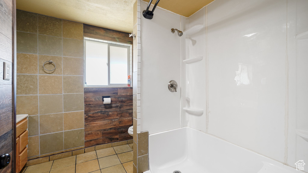 Full bath featuring tile patterned flooring, a shower, and vanity