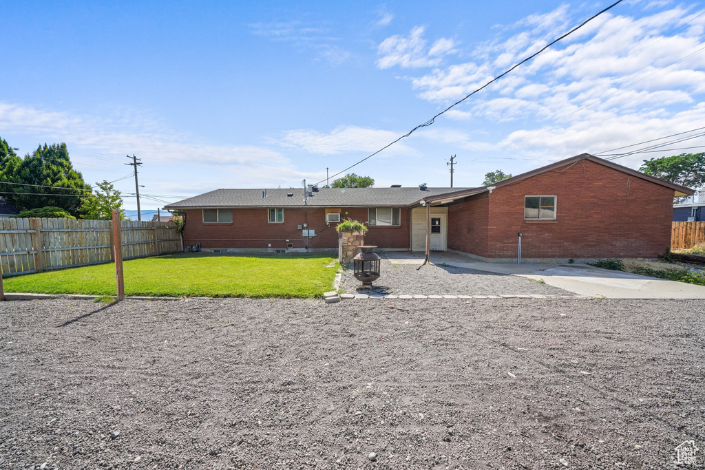 Rear view of house featuring brick siding