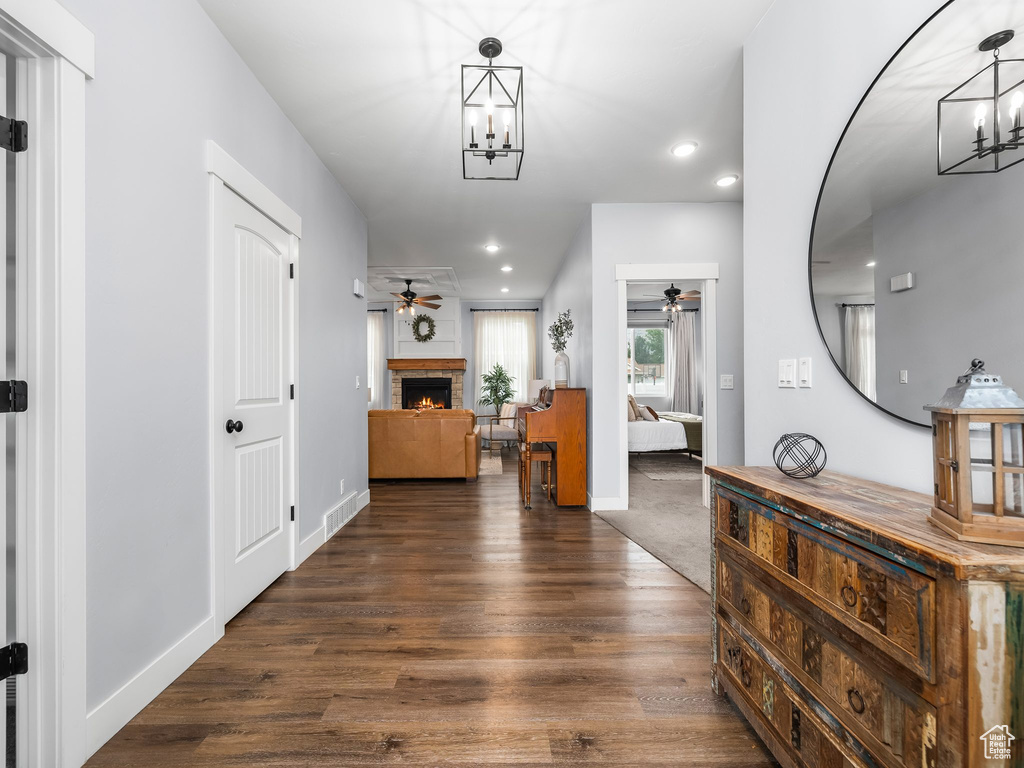Foyer entrance with a chandelier, ceiling fan, dark wood-type flooring, and recessed lighting