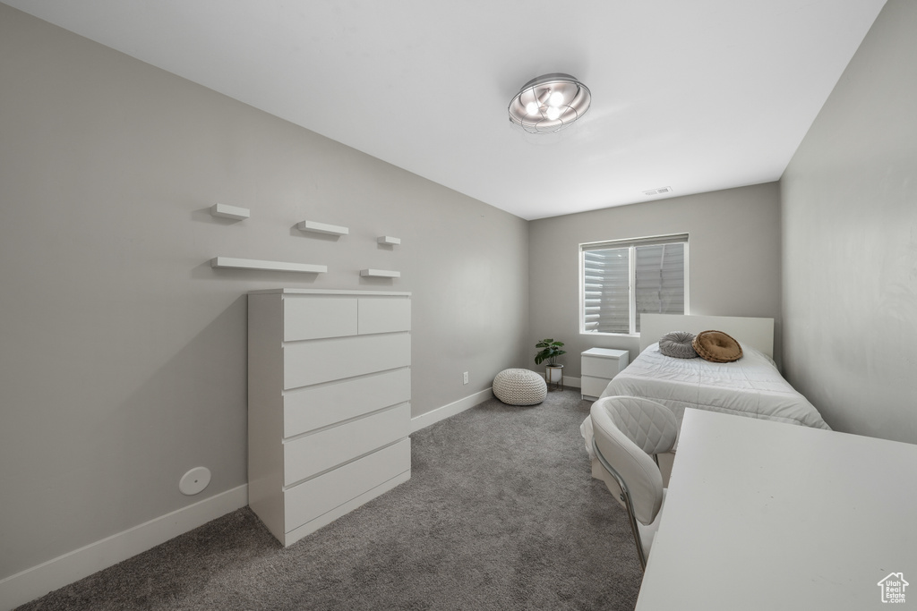 Carpeted bedroom featuring baseboards