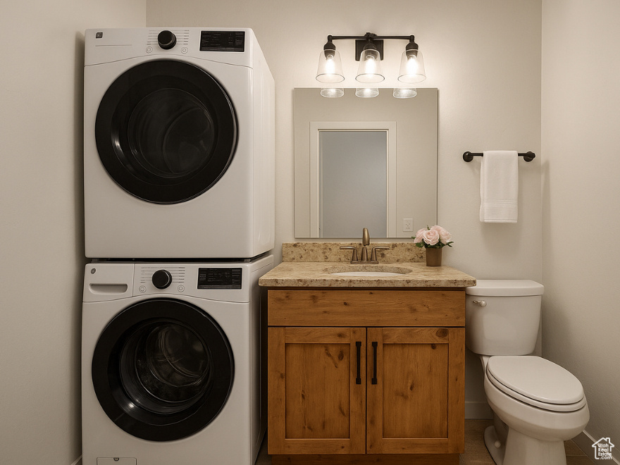 Half bathroom with estacked washer and dryer and vanity