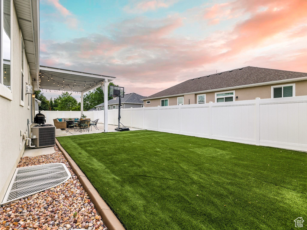 Fenced backyard with a patio and an outdoor living space