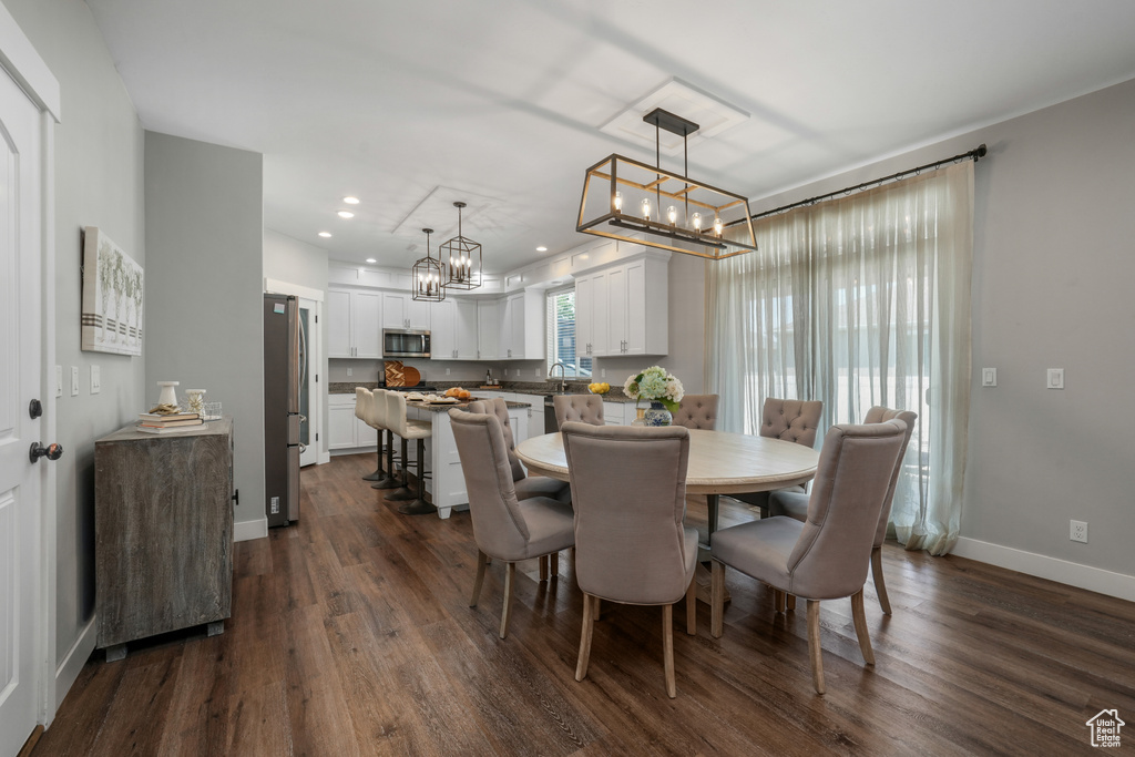 Dining space featuring a chandelier, dark wood-style flooring, and recessed lighting