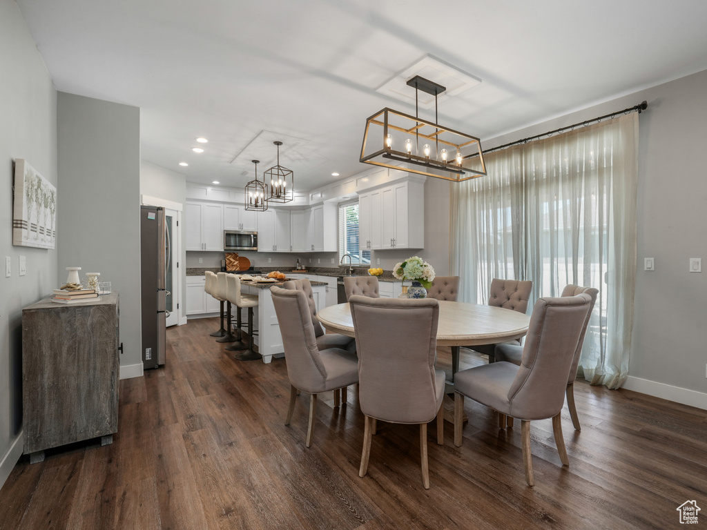 Dining space featuring a chandelier, dark wood-style flooring, and recessed lighting