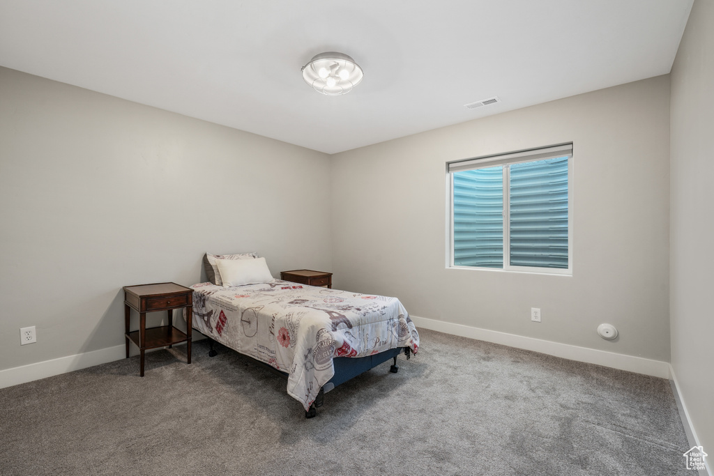 Bedroom featuring baseboards and carpet floors