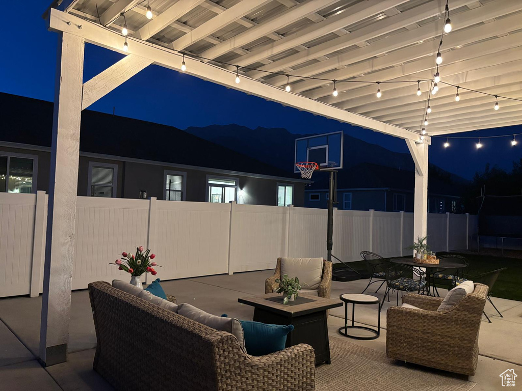 Patio at twilight featuring a patio area, outdoor dining area, and outdoor lounge area