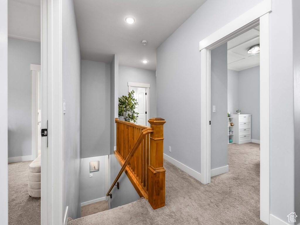 Corridor featuring an upstairs landing, carpet floors, and recessed lighting