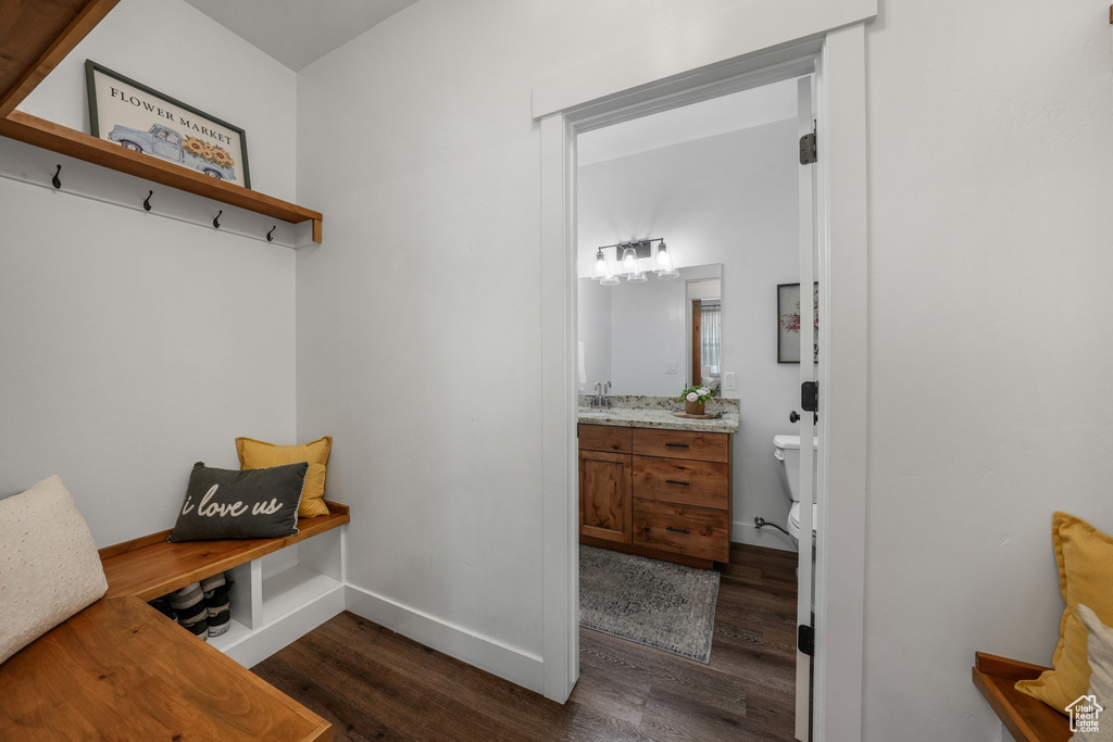 Mudroom with dark wood-style floors and baseboards