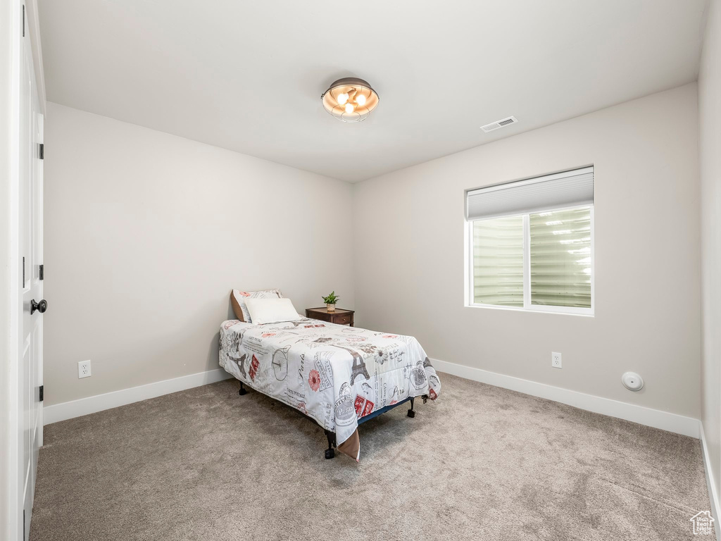 Carpeted bedroom featuring baseboards