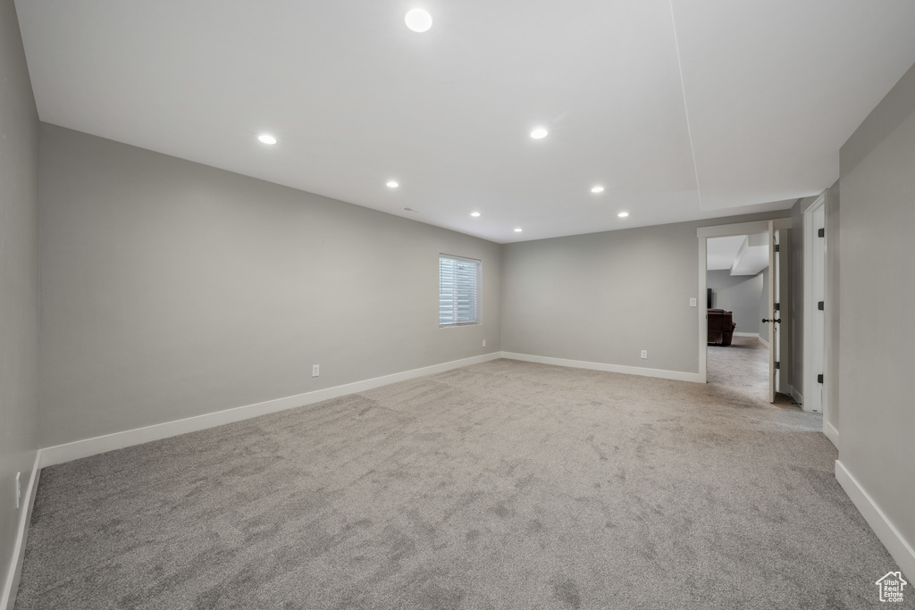 Unfurnished room with light colored carpet and recessed lighting
